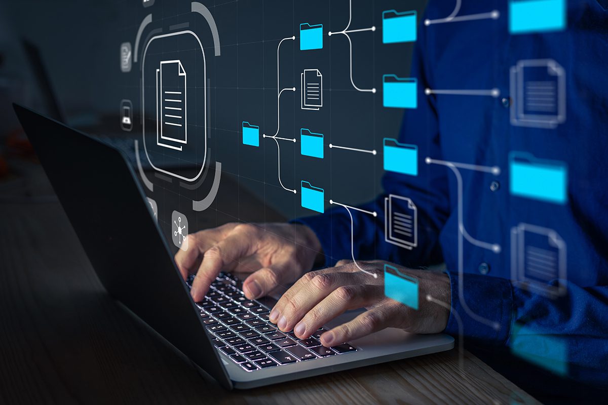 A holographic representation of a data structure is superimposed over a laptop